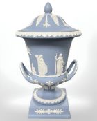 A Wedgwood blue Jasperware twin-handled lidded campana urn on plinth, height 30 cm.