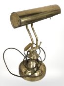A brass adjustable desk lamp,
