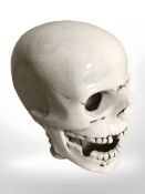 A white glazed pottery skull signed 'Marc', height 21 cm.