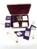 An ornate metal casket containing jewellery, mostly sterling silver earrings,