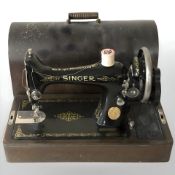 A Singer hand sewing machine.