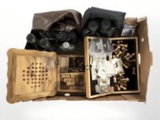 A group of boxwood chess pieces, several pairs of binoculars, dominoes, John Player cigarette cards,