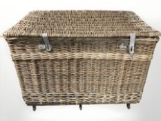 A large wicker chest with galvanized metal fittings,
