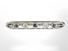 A 14ct yellow gold bar brooch set with two small diamonds and three sapphires, length 30 mm.
