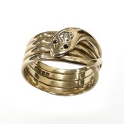 An 18ct yellow gold ring formed as a coiled snake, set with ruby eyes and an old round cut diamond,