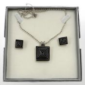 A sterling silver necklace with with pendant and matching pair of earrings