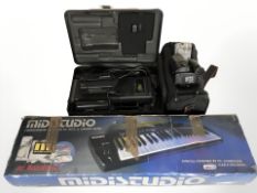 A boxed digital keyboard and two Sony video cameras