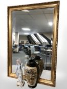 A reproduction gilt and bevelled rectangular mirror, 96 cm x 66 cm,