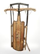 An early 20th century painted pine sledge,