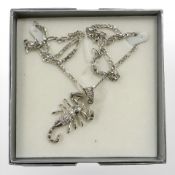 A sterling silver necklace with silver scorpion pendant