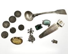 A silver caddy spoon, bookworm bookmark, several pieces of jewellery,