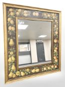 An antique style mirror with frame decorated with fruit, 82 cm x 92 cm.