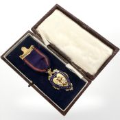 A 9ct yellow gold and enamel Order of Odd Fellows Manchester Unity medal dated 1933