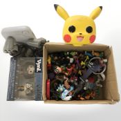 A Sony Playstation 1 mini, with two controllers, various toys including Pokemon,
