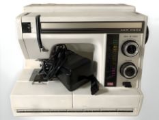 A Newhome electric sewing machine with lead and pedal.