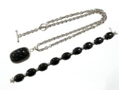 A Sterling silver necklace with polished black pendant together with matching bracelet
