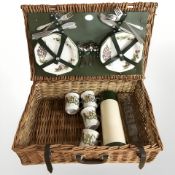A wicker picnic hamper and contents