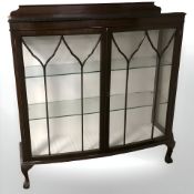 An early 20th century mahogany bow front double door display cabinet,