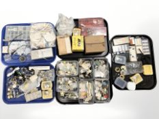 A large quantity of horologist parts and spares, movements, dials, watch crystals, springs, pins,