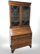 A late Victorian mahogany and satin inlaid bureau bookcase,