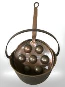 A Victorian brass and cast iron jam pan and a copper cooking skillet.
