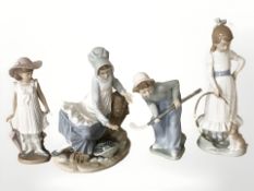 Three Nao figures of children including boy with hockey stick,