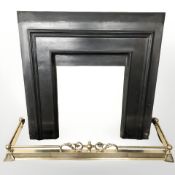 A brass fire curb and cast iron fire surround