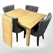 A contemporary oak extending rectangular dining table,