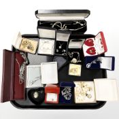 A group of boxed costume jewellery items, pendants on chains,