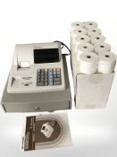 A Sharp XE-110 cash register and receipt rolls,
