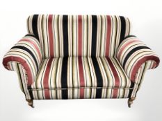 A contemporary Victorian style two seater settee, in striped fabric,