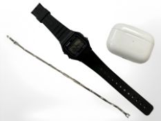 A sterling silver bracelet together with Apple Airpods and Casio digital watch