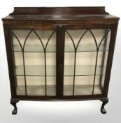 An early 20th century mahogany bow front double door display cabinet,