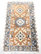 A woolen rug of Persian design 127 cm x 65 cm