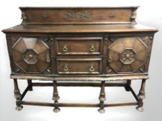An Edwardian carved oak bow-front sideboard,
