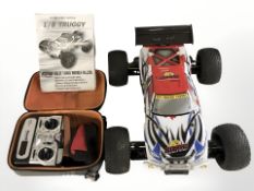 A remote control 4x4 racing car, with controller.