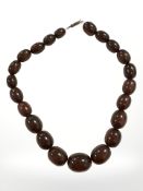 A cherry amber/Bakelite bead necklace with silver clasp