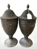 A pair of patinated metal lidded urns, height 36 cm.