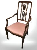 An Edwardian walnut and mahogany armchair