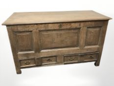 A George III oak mule chest carved with the initials RHE.