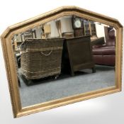 A reproduction gilt and bevelled overmantle mirror,