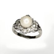 A 14ct white gold ring, set with a pearl surrounded with diamonds, size L.