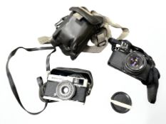 A Pentax MV camera 1:2 50 mm, together with an Olympus Trip 35 camera.