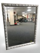 A contemporary silvered and bevelled mirror,