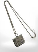 A Sterling silver chain with silver 'stamp' envelope suspended as a pendant