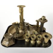 An oversized brass chamber stick plus smaller examples, set of four candlesticks,