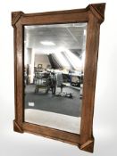 An Edwardian carved oak and bevelled mirror,