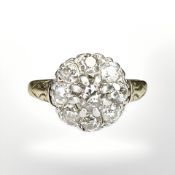 An 18ct gold and platinum cluster ring, with nine old-cut stones in claw settings,