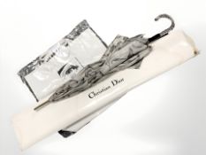 A Christian Dior umbrella and a Calvin Klein shoulder bag