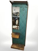 A teak hat and coat stand with mirrored back,